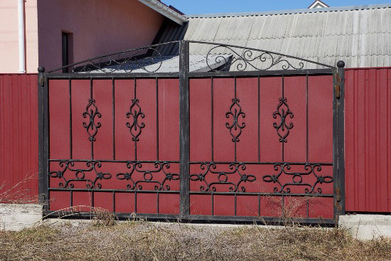 Red-colored iron has fireplace doors installed for a house in Oklahoma City, OK