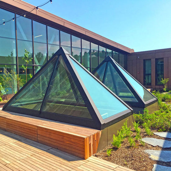 A glass pyramid skylight rests elegantly on a wooden deck in Oklahoma City, OK