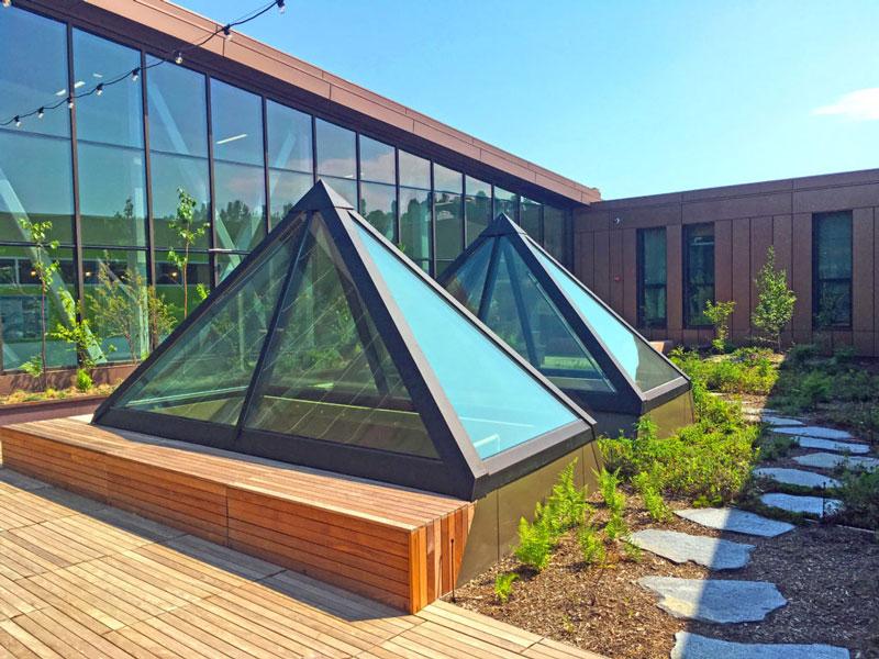 Central glass pyramid within a building in Oklahoma City, highlighting custom skylights